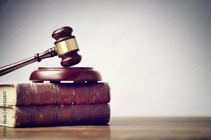 Judge gavel and law books in court background with copy space