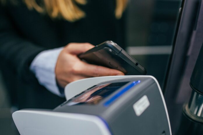 Mobile payment using phone at a terminal. Picture taken by Jonas Leupe (www.brandstof.studio) for In The Pocket (www.inthepocket.com)